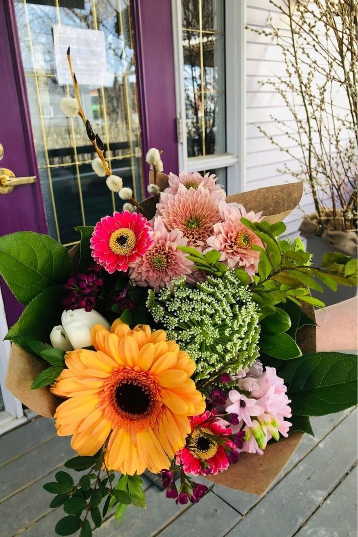 Bright, colorful bouquet featuring orange and pink gerbera daisies, pink chrysanthemums, and pussy willows.